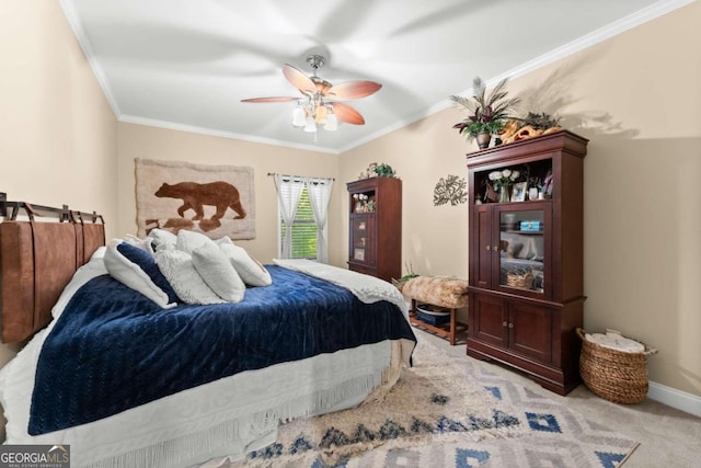 bedroom featuring light carpet, baseboards, a ceiling fan, and crown molding