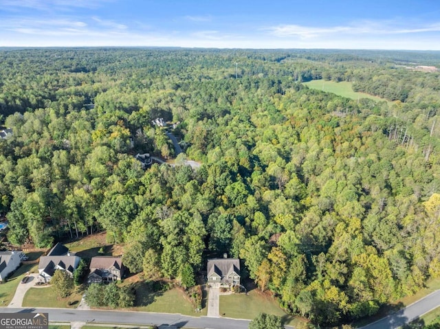 aerial view featuring a wooded view