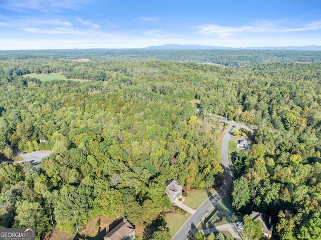 bird's eye view featuring a wooded view