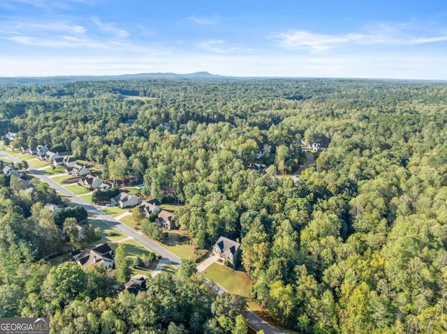 drone / aerial view with a residential view and a view of trees