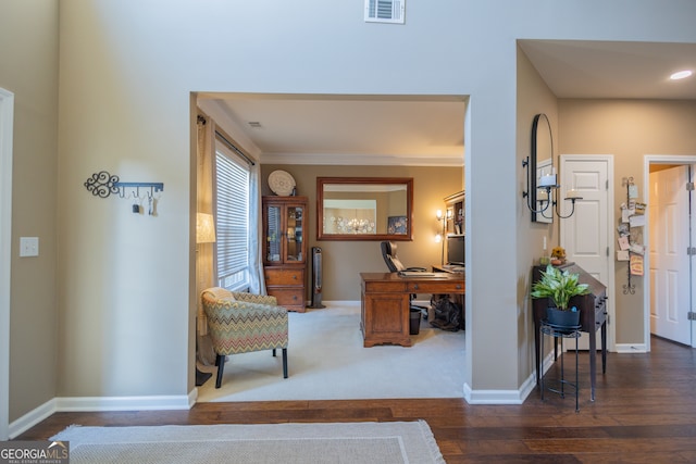 foyer entrance featuring ornamental molding and dark hardwood / wood-style flooring