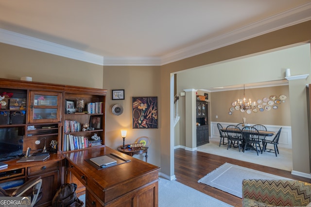 office space with crown molding, a notable chandelier, ornate columns, and light hardwood / wood-style floors