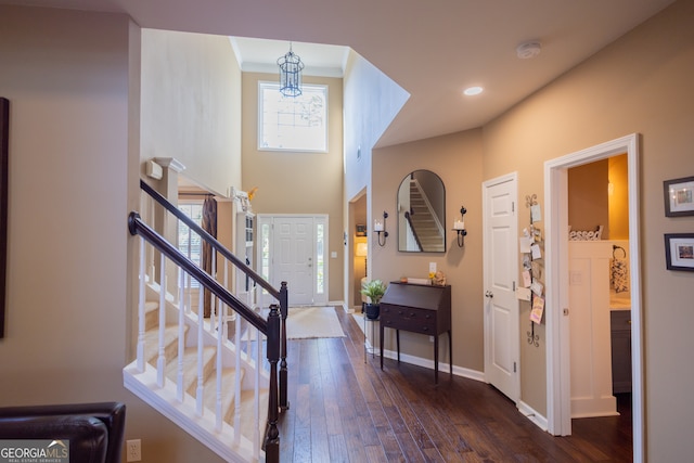 foyer featuring ornamental molding and dark hardwood / wood-style floors