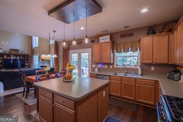 kitchen with appliances with stainless steel finishes, dark hardwood / wood-style floors, a healthy amount of sunlight, and a kitchen island