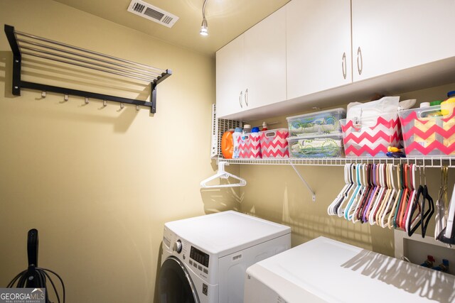 laundry room featuring cabinets