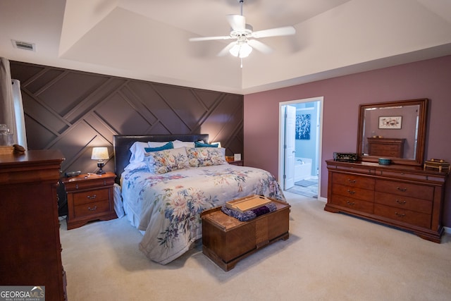 carpeted bedroom with connected bathroom and ceiling fan