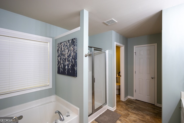 full bathroom with vanity, shower with separate bathtub, and toilet