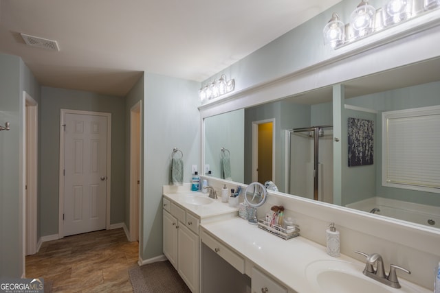 bathroom with vanity and independent shower and bath