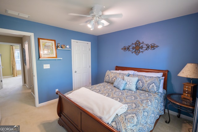 bedroom featuring light colored carpet and ceiling fan