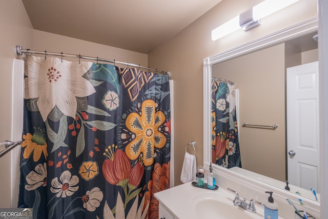 bathroom featuring vanity and curtained shower