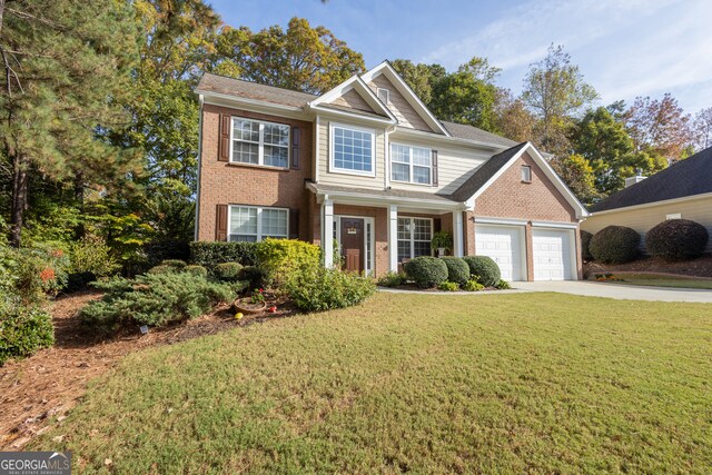 view of front of home with a front lawn and a garage