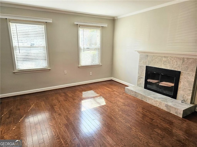 unfurnished living room with crown molding, a fireplace, and dark hardwood / wood-style flooring