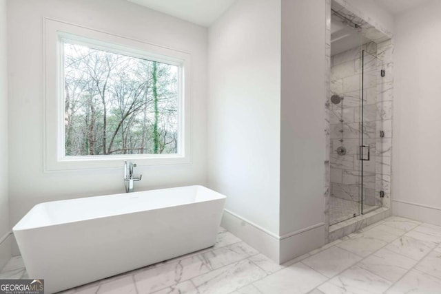 bathroom featuring shower with separate bathtub