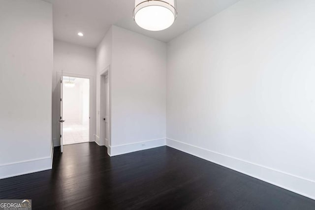 spare room with dark wood-type flooring