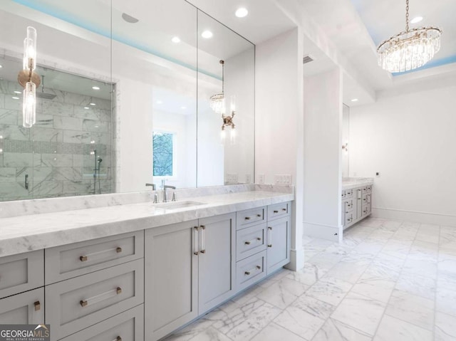 bathroom featuring vanity, an inviting chandelier, and an enclosed shower