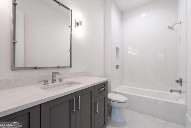 full bathroom with toilet, tiled shower / bath, and vanity