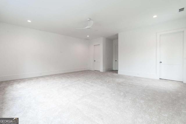 carpeted spare room featuring ceiling fan