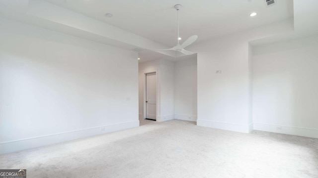 carpeted spare room with ceiling fan