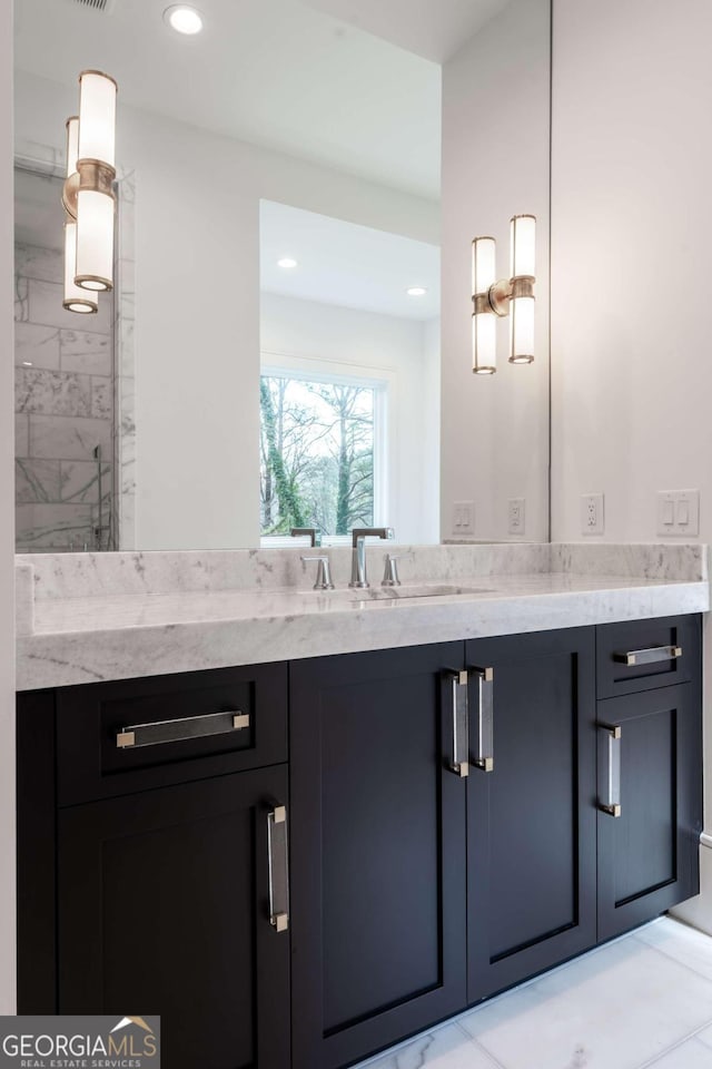 bathroom with vanity, a shower with shower door, and tile patterned floors