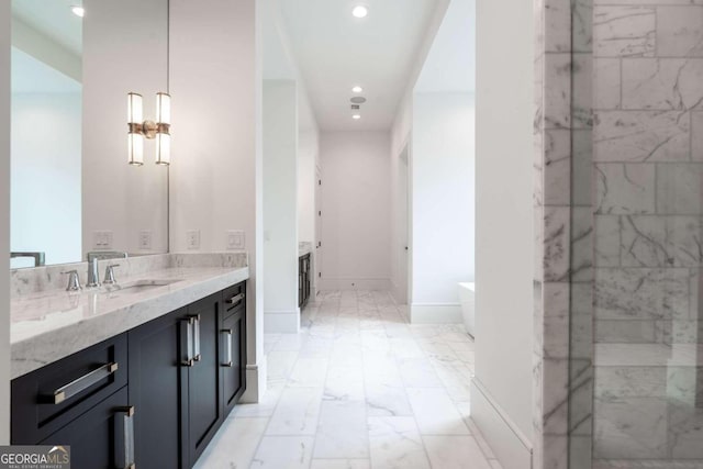 bathroom featuring vanity and a tub