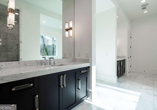 bathroom with vanity and tiled shower