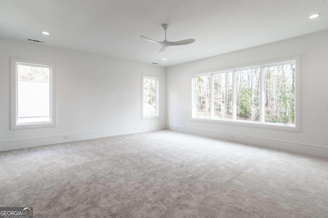 carpeted empty room featuring ceiling fan