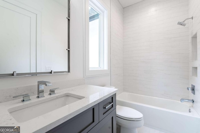 full bathroom with vanity, toilet, a healthy amount of sunlight, and tiled shower / bath combo