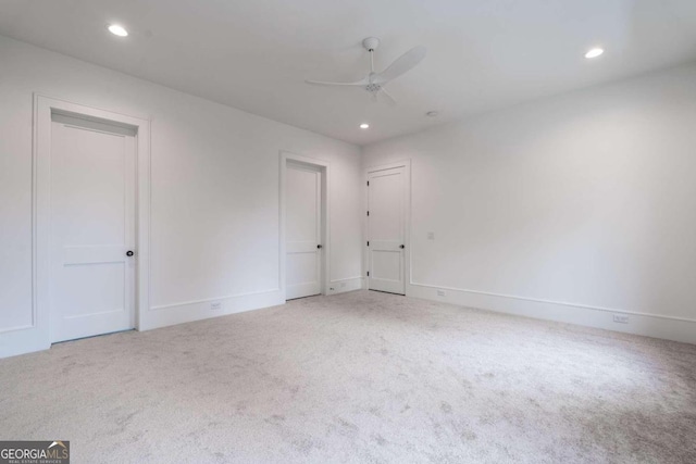 carpeted empty room featuring ceiling fan