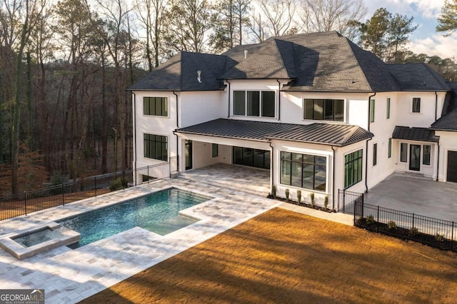 rear view of property with a patio area and a fenced in pool