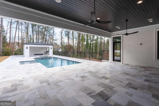 view of pool with an in ground hot tub, a patio, and ceiling fan