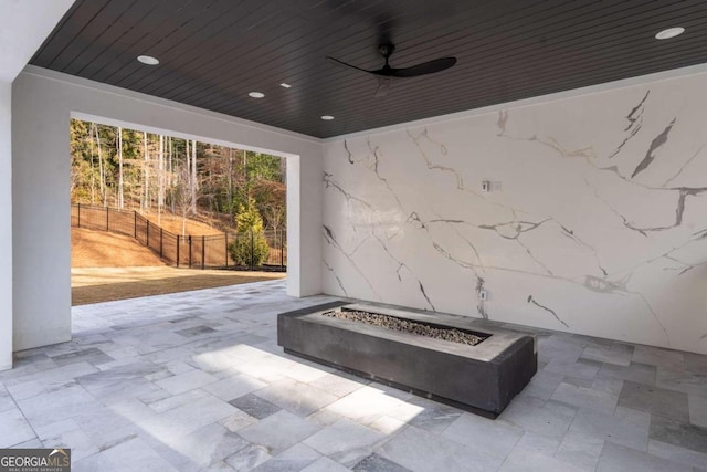 view of patio with an outdoor fire pit and ceiling fan