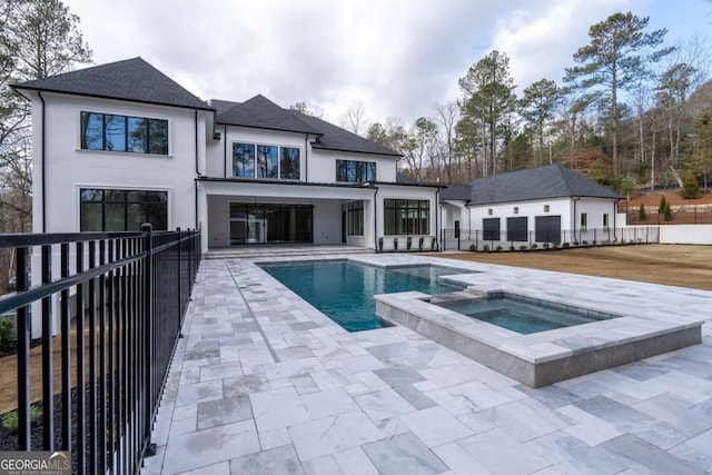 view of swimming pool featuring an in ground hot tub and a patio