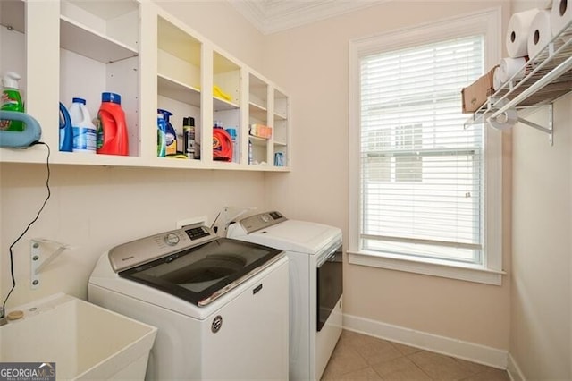 laundry area with ornamental molding, sink, washer and clothes dryer, and plenty of natural light