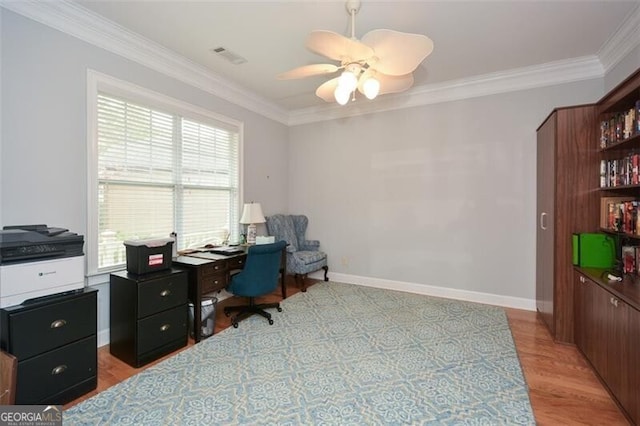 office area featuring ceiling fan, crown molding, a wealth of natural light, and light wood-type flooring