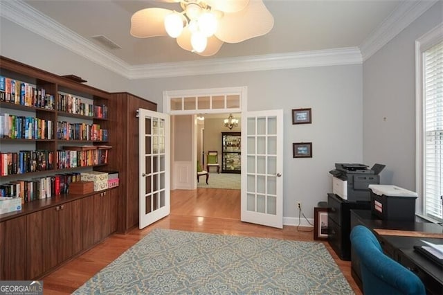 office area with light hardwood / wood-style flooring, french doors, and a healthy amount of sunlight