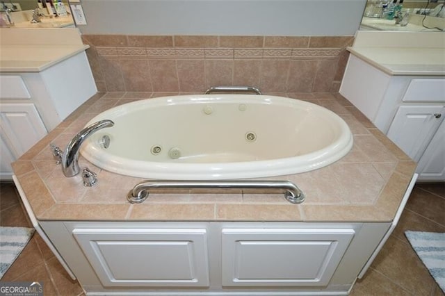 bathroom with a bath and tile patterned floors