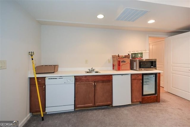 kitchen with white dishwasher, wine cooler, and light carpet