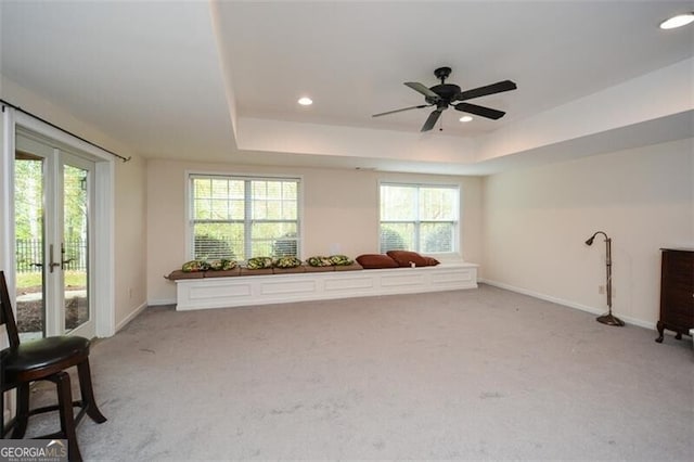 interior space featuring ceiling fan and a raised ceiling