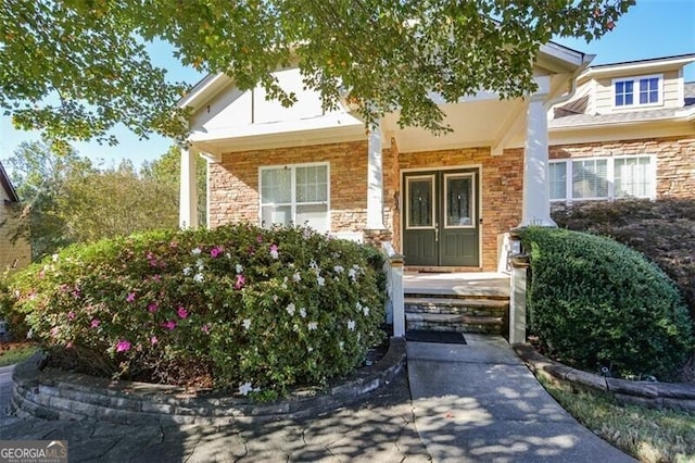 view of exterior entry with a porch