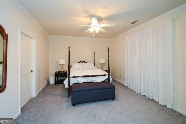 carpeted bedroom with ceiling fan and ornamental molding