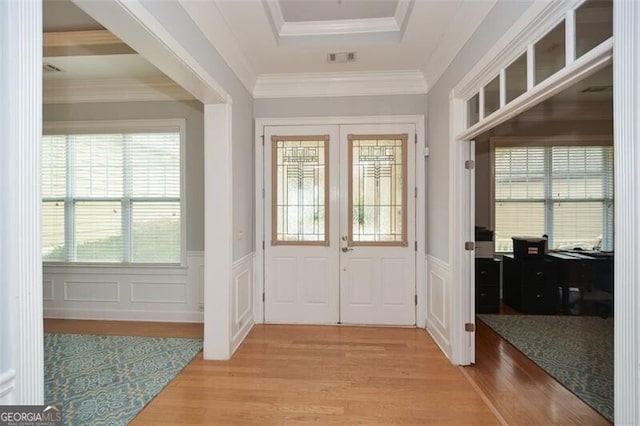 doorway featuring french doors, ornamental molding, and light hardwood / wood-style flooring