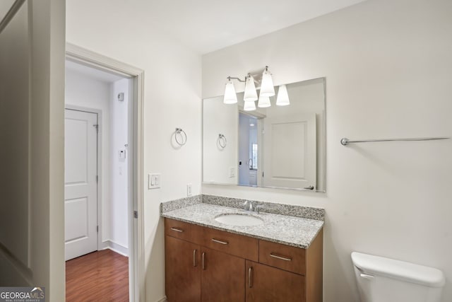 bathroom featuring vanity, a shower with door, tile patterned flooring, and toilet