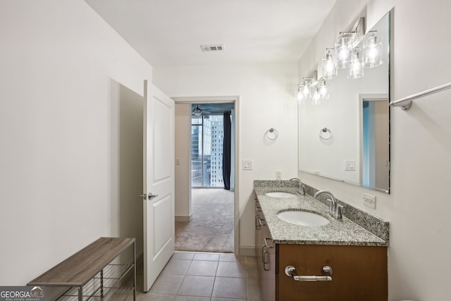 bathroom featuring tile patterned flooring and vanity