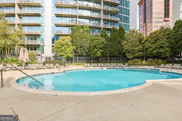 view of property's community with a patio and a fire pit