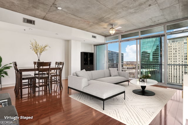 living room with expansive windows, hardwood / wood-style flooring, and ceiling fan