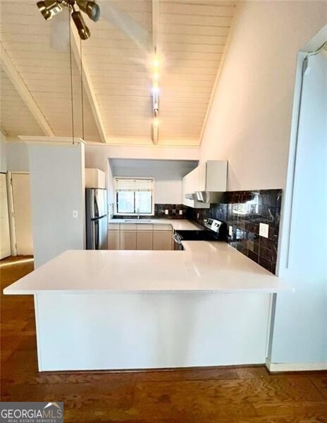 kitchen with kitchen peninsula, stainless steel appliances, vaulted ceiling, wooden ceiling, and dark hardwood / wood-style floors