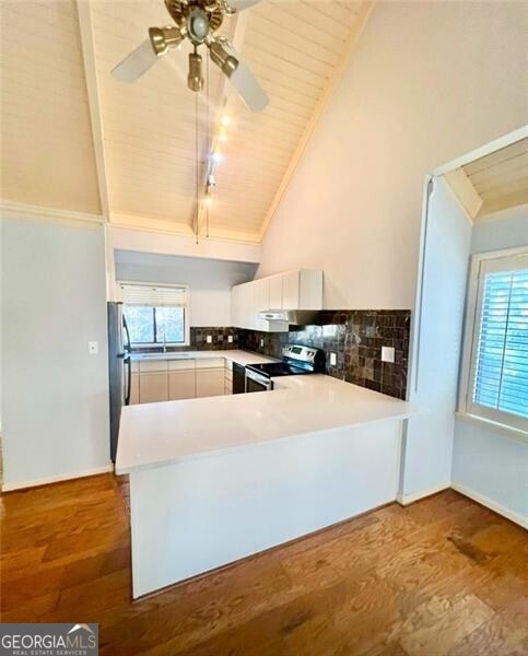 kitchen featuring kitchen peninsula, stainless steel appliances, white cabinets, and wooden ceiling