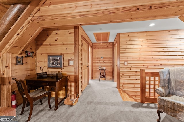 living area with wood walls, vaulted ceiling, and light carpet