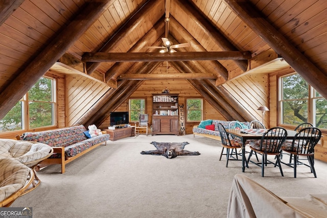 interior space with multiple windows, vaulted ceiling with beams, wood ceiling, and wood walls