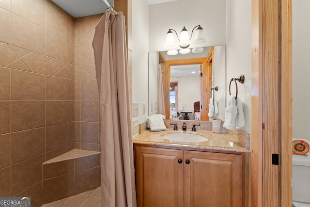 bathroom with walk in shower and vanity